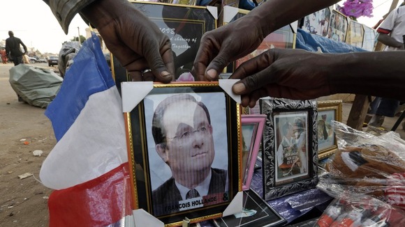 Malians display a picture of French President Francois Hollande for sale in Bamako market