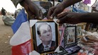 Malians display a picture of French President Francois Hollande for sale in Bamako market