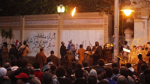 Protesters throw stones at security forces inside the presidential palace.
