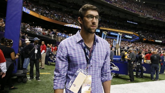 Former Olympic swimmer Michael Phelps watches from the sidelines.