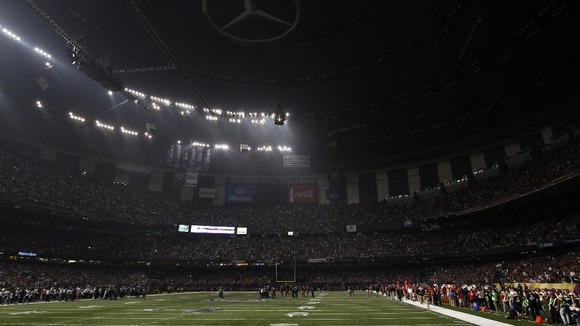 Play is halted after half of the lights went out during the Super Bowl game between the Baltimore Ravens and the San Francisco 49ers.