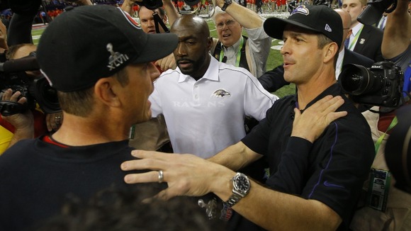 San Francisco 49ers head coach Jim Harbaugh (L) congratulates his brother, Baltimore Ravens head coach John Harbaugh, after the Ravens won.