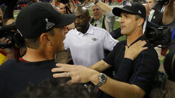 San Francisco 49ers head coach Jim Harbaugh (L) congratulates his brother, Baltimore Ravens head coach John Harbaugh, after the Ravens won.