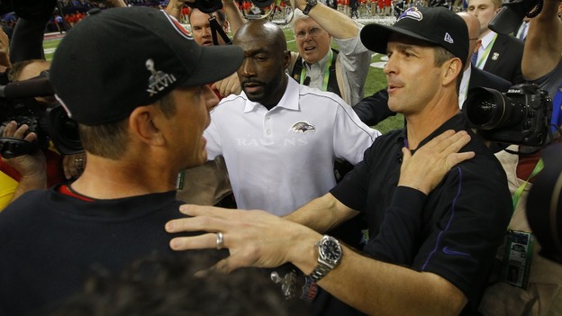 San Francisco 49ers head coach Jim Harbaugh (L) congratulates his brother, Baltimore Ravens head coach John Harbaugh, after the Ravens won.