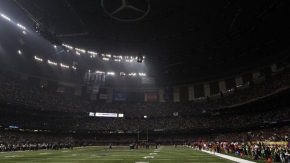 Play is halted after half of the lights went out during the Super Bowl game between the Baltimore Ravens and the San Francisco 49ers