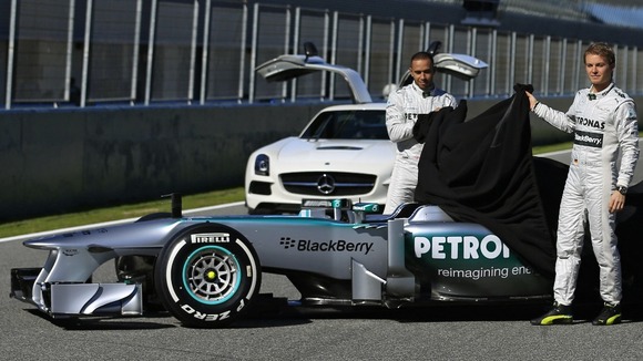 Lewis Hamilton and team mate Nico Rosberg of Germany unveil the new Mercedes W04 Formula One car