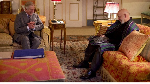 Prince Charles and President Hamid Karzai laugh as they begin their meeting.