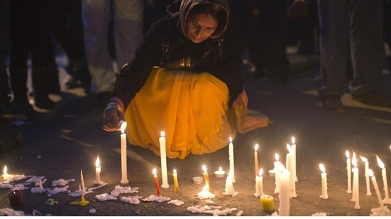A demonstrator lights candles during a vigil for the victim who was assaulted in New Delhi, on December 29.
