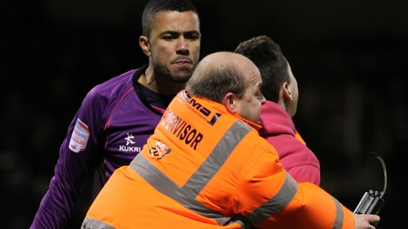 The teenager was dragged away by stewards after confronting Archer (left)
