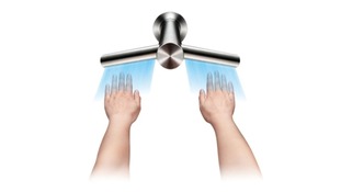 Hands being dried by tap