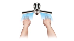 Hands being dried by tap