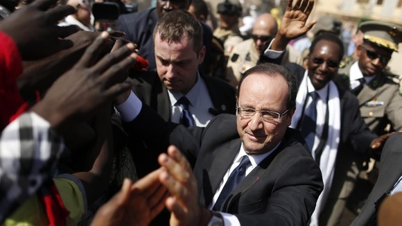 France's President Francois Hollande greets people in the centre of Timbuktu on February 2 2013