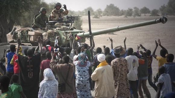 French troops aboard a tank are greeted by Malians as they arrived in Timbuktu in January