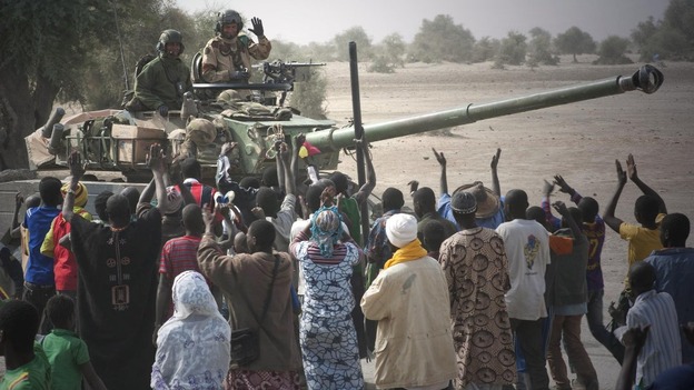 French troops aboard a tank are greeted by Malians as they arrived in Timbuktu in January