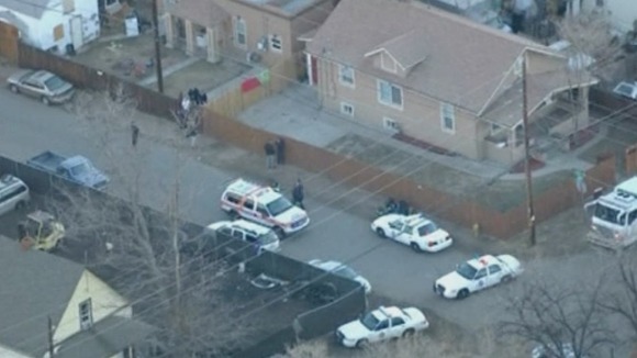 Police surround the house where the fatal shooting tool place