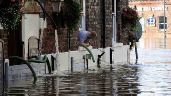 A man watches flood water rise in York as the River Ouse rises after flood in September 2012