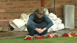 Ethan's friend lays flowers at his home in Sheldon