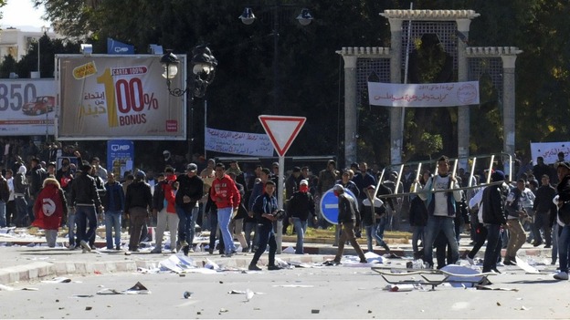 Protesters gesture at policemen during a demonstration in Gafsa yesterday 