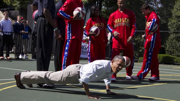President Barack Obama does pushups during the White House Easter Egg Roll hosted by the president and first lady Michelle Obama.
