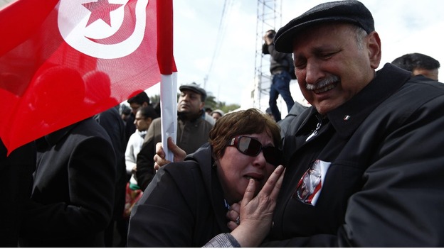 A couple mourns during the funeral procession for the late secular opposition leader Chokri Belaid 
