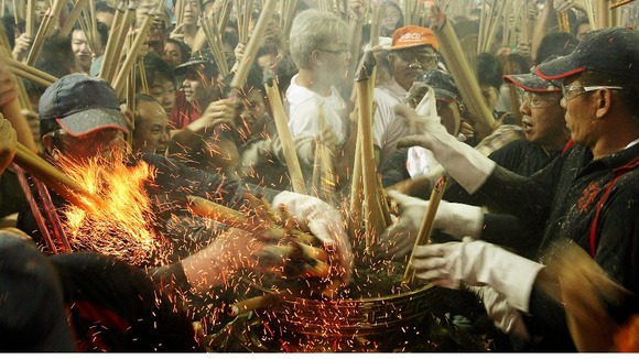 Worshippers rush to place joss sticks at the Kwan Im Thong Hood Cho temple in Singapore