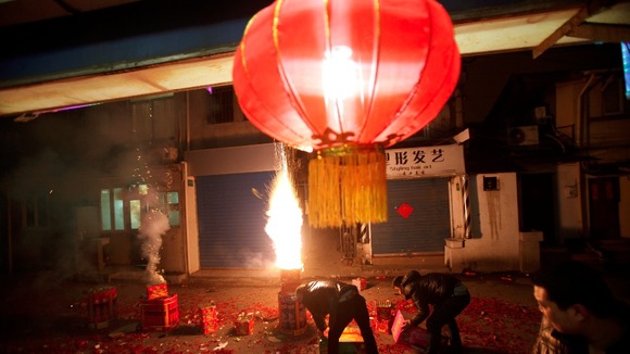 Men set off fireworks as residents celebrate the start of the Chinese New Year in Shanghai