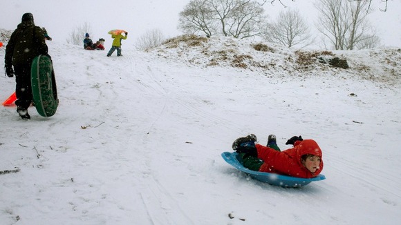 DATE IMPORTED:February 8, 2013A boy sleds down a hill at a golf course during a snow storm in Pelham Manor, New York