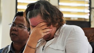 Lindsay Sandiford with her translator listens to the judge during a her trial