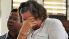 Lindsay Sandiford with her translator listens to the judge during a her trial
