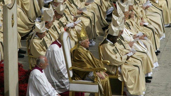 Pope Benedict XVI sits with cardinals during his inaugural mass in St. Peter's Square in the Vatican April 24, 2005.
