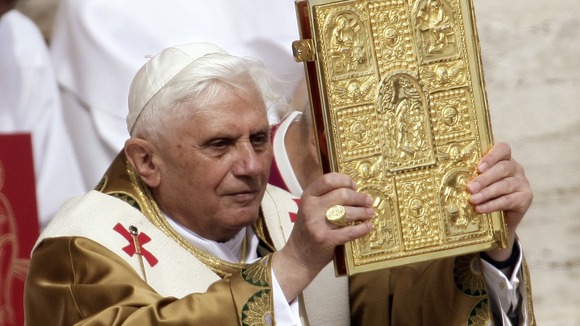 The Pope holds up the gospels in St. Peter's Square.