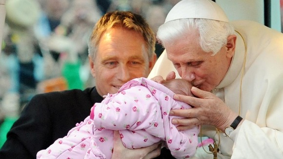Pope Benedict XVI blessing a baby as he arrives in Hyde Park for a Prayer Vigil.