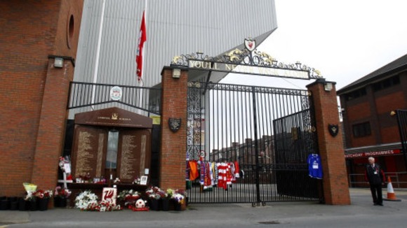 Tributes outside the gates next to the Hillsborough Memorial at Anfield.