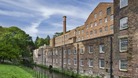 The dramatic backdrop of Quarry Bank Mill from the Mill meadow.