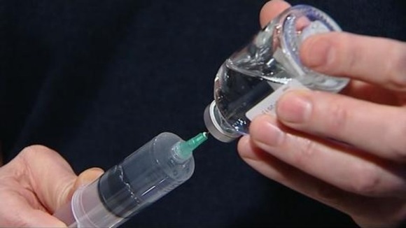 Kathryn's husband fills a syringe with the drug which helps keep her alive