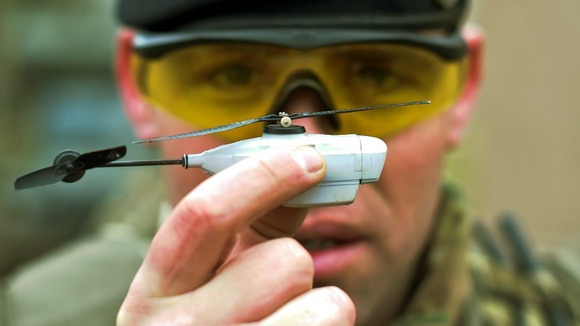 Sergeant Carl Boyd of the 1st Royal Regiment of Fusiliers shows off a remote controlled miniature helicopter with three cameras on-board