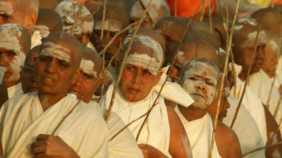 Newly initiated Sadhvis return to their camp after attending a ritual as part of the Kumbh Mela festival