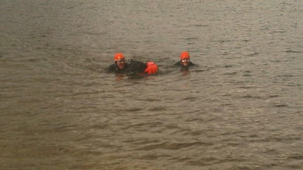 Taking a dip with his owners