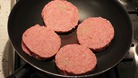 A general view of burgers in a pan.