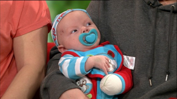 Dennie sits in his father arms with a bandaged hand after the fox attack