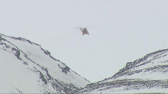 One of the RAF helicopters hovers over the Chalamain Gap area of the Cairngorms.