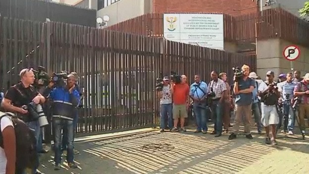 Reporters and photographers crowding the entrance to the court