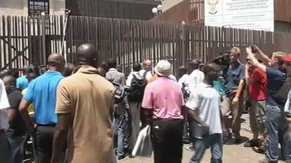 Photographers and reporters outside the court gates
