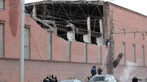 Workers repair damage caused after a meteorite passed above the Urals city of Chelyabinsk