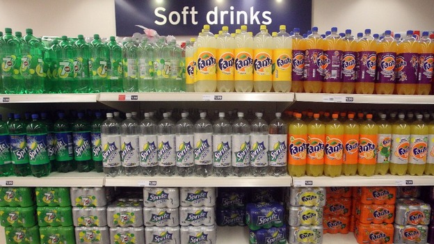 Rows of soft drinks on supermarket shelving
