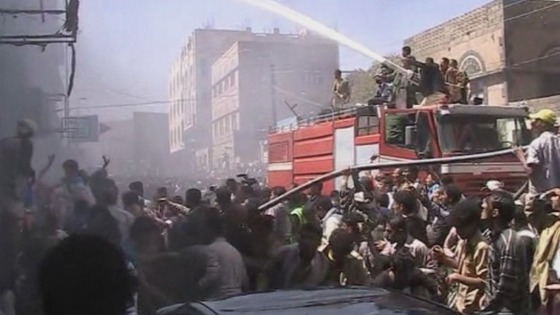 Crowds of people gather as firefighters try and put out the blaze.