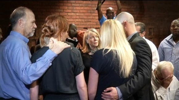 Oscar Pistorius' family console each other during a break in proceeding