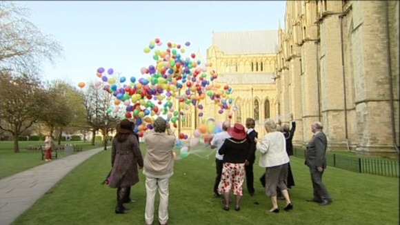 People releasing balloons