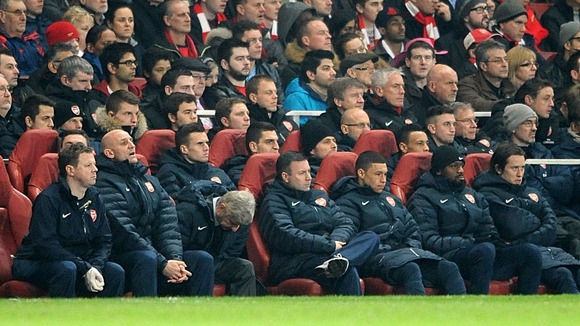 Arsene Wenger hangs his head in despair as Bayern cruise into half-time lead