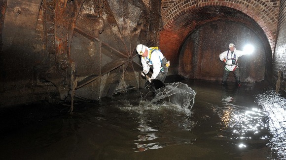 workmen in sewer